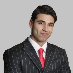 Portrait of young business team with arms crossed over colored background